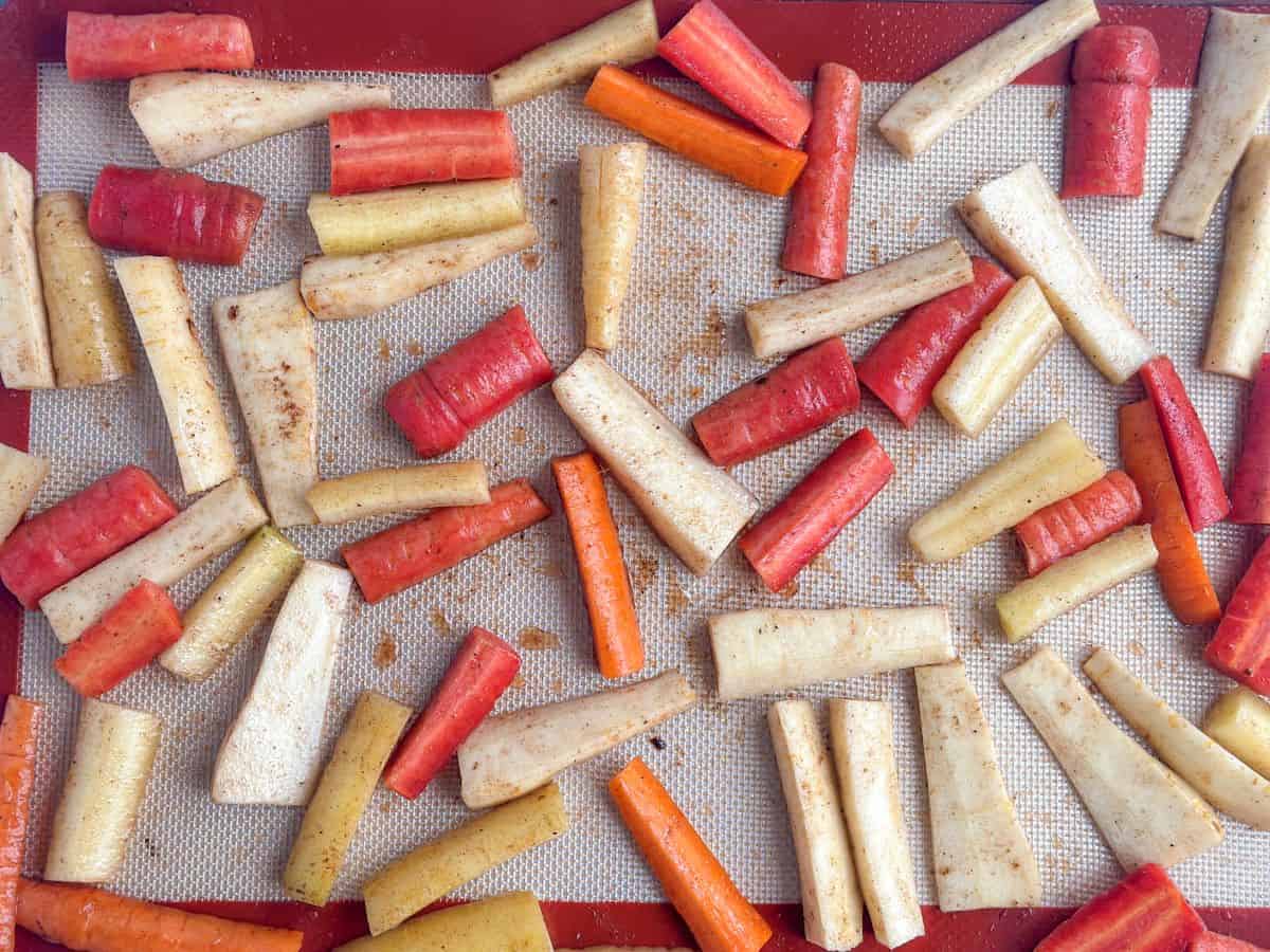carrots-parsnips-sliced-on-baking-sheet