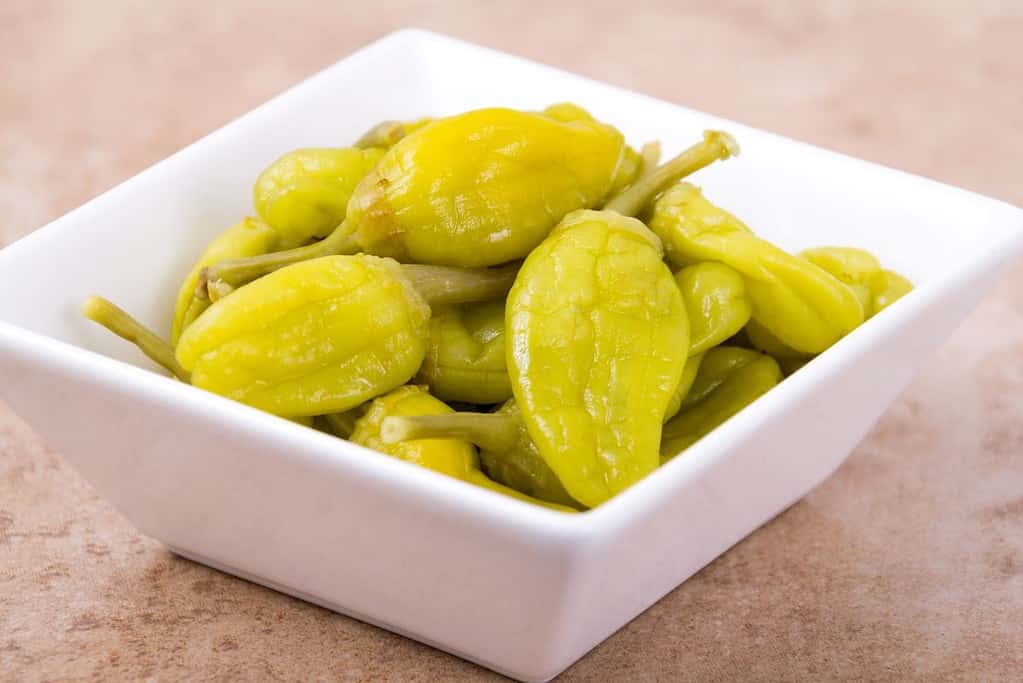 pepperoncini in a small white bowl