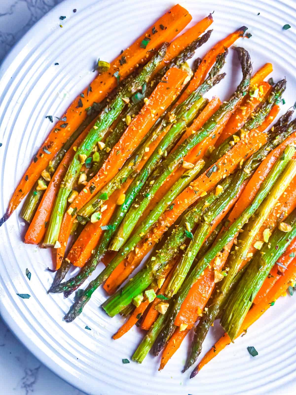 roasted carrots and asparagus on white serving plate