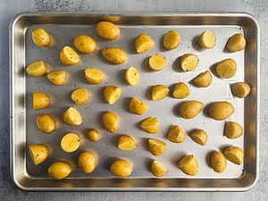 Baby yellow potatoes on a large baking sheet.