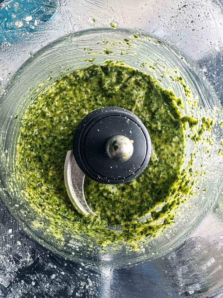 Basil pesto in the bowl of food processor.