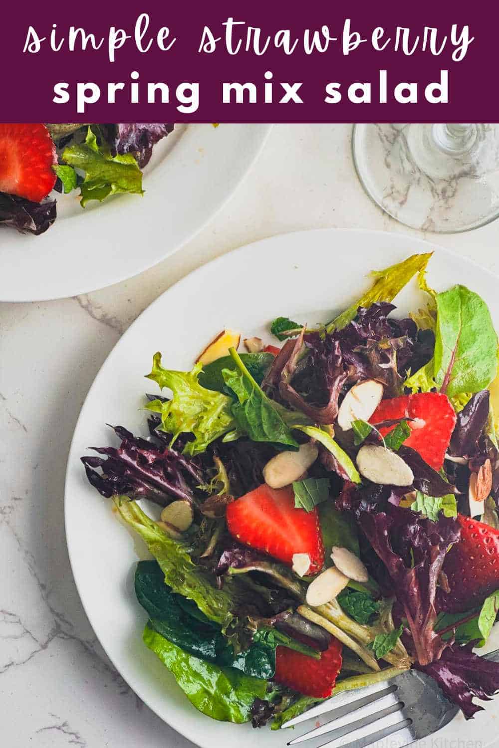 Pinterest pin image of the strawberry spring mix salad on white plates with the title above.