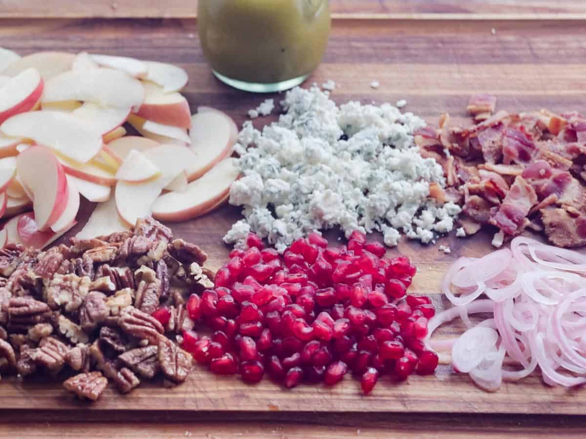 Ingredients for an ultimate fall apple salad on a cutting board.