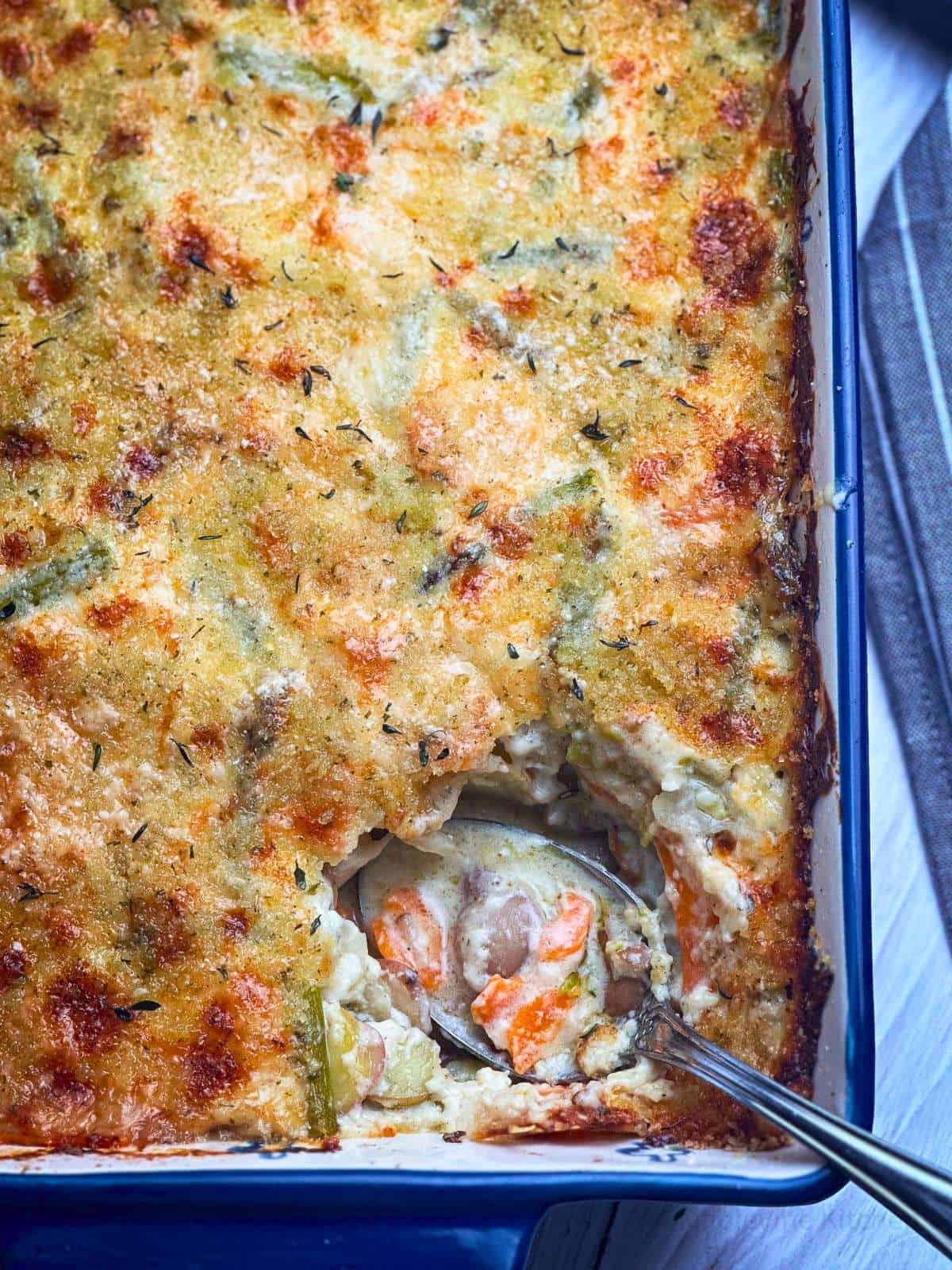 Cheesy spring vegetable au gratin casserole with golden crust.