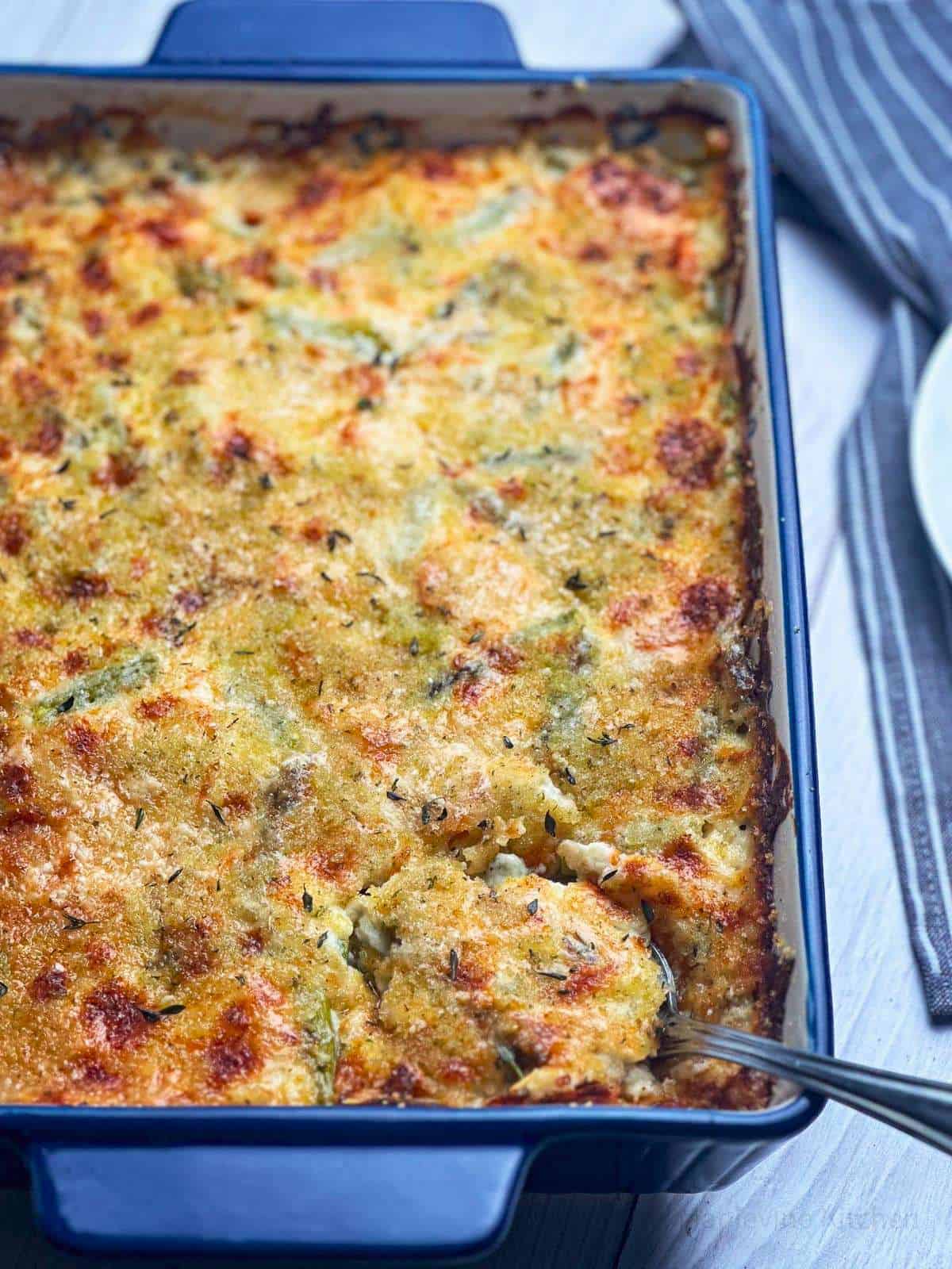 Spring vegetable casserole in a blue baking dish.