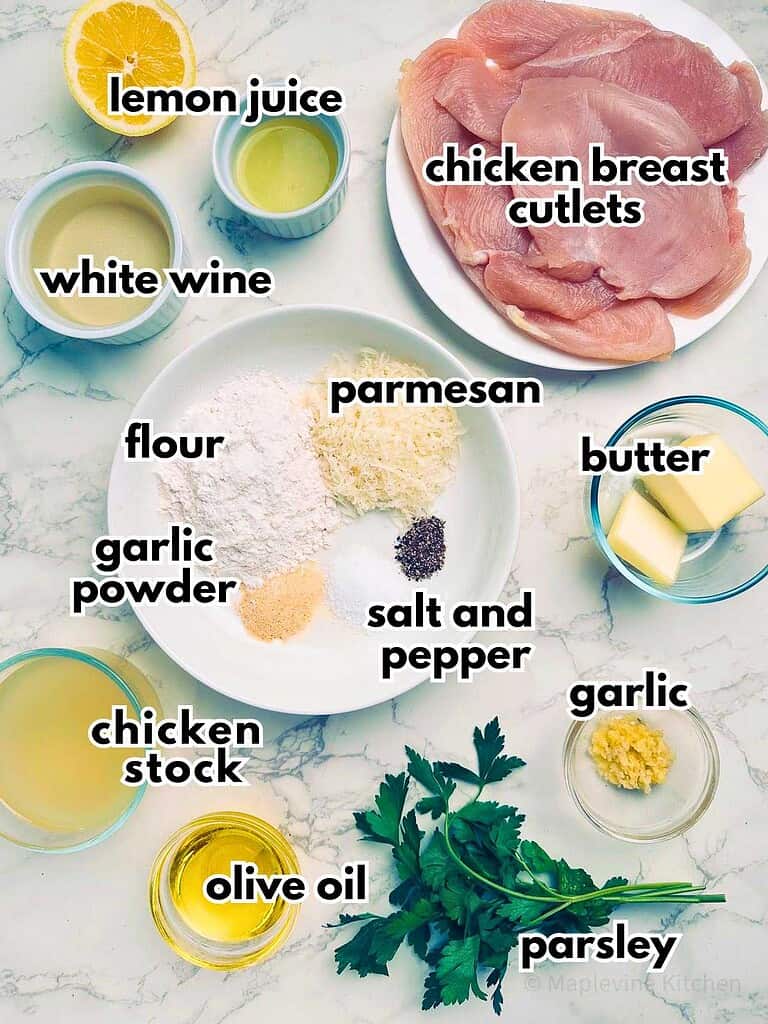 Ingredients for lemon chicken cutlets: lemon juice, chicken breast, garlic, parsley, olive oil, flour, parmesan, butter, salt, pepper, white wine.