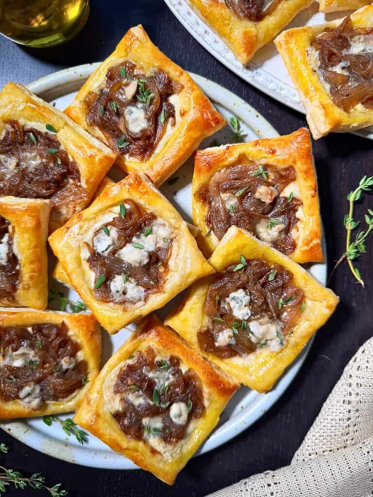 Caramelized onion and blue cheese tarts with flaky puff pastry and fresh thyme from Maplevine Kitchen.