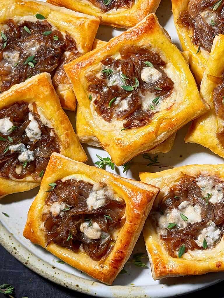 Caramelized onion puff pastry tarts with Gorgonzola and thyme.