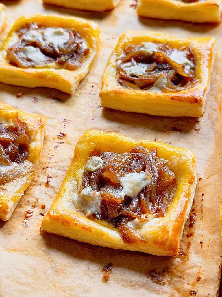 Caramelized onion puff pastry tarts with Gorgonzola cheese.